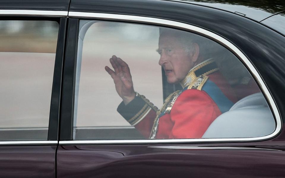 Britain's King Charles III waves from the car as he arrives at Buckingham Palace for the King's Birthday Parade - ADRIAN DENNIS/AFP via Getty Images