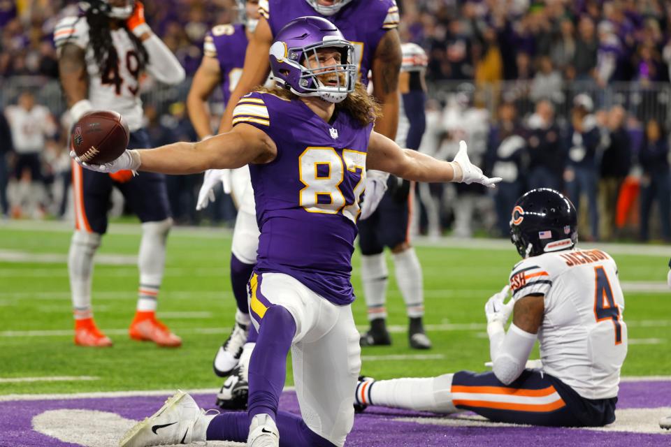 Minnesota Vikings tight end T.J. Hockenson (87) celebrates in front of Chicago Bears safety Eddie Jackson (4) after catching a touchdown pass during the second half of an NFL football game, Monday, Nov. 27, 2023, in Minneapolis. (AP Photo/Bruce Kluckhohn)