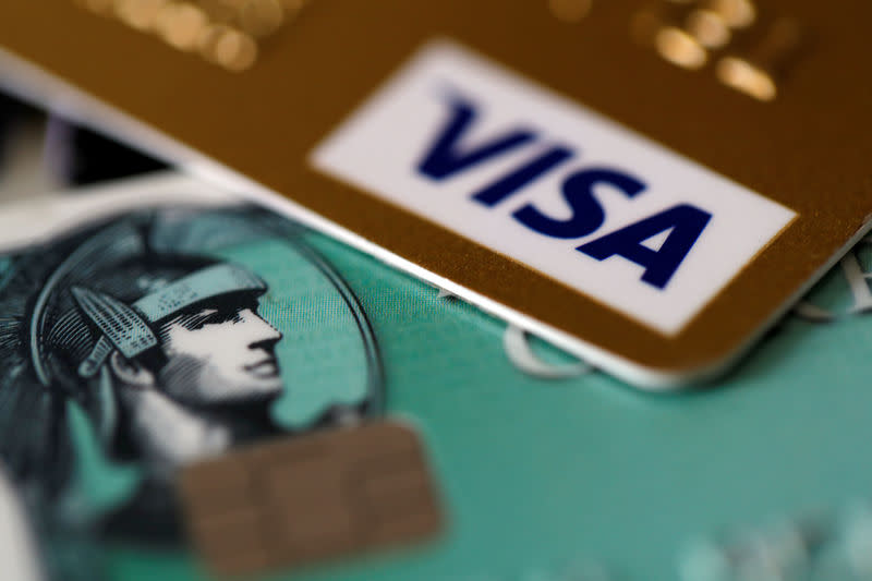 An American Express and a Visa credit cards are seen on a computer keyboard in this picture illustration taken September 6, 2017. REUTERS/Philippe Wojazer/Illustration/Files