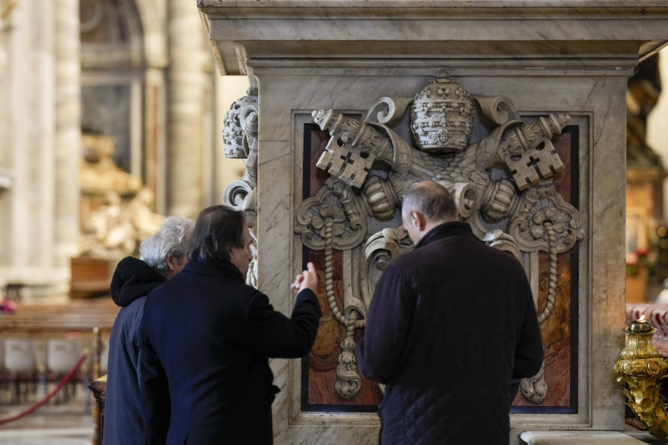 Workmen inspect the base of one of the columns of the 17th century, 95ft-tall bronze canopy by Giovan Lorenzo Bernini surmounting the papal Altar of the Confession in St. Peter's Basilica at the Vatican, Wednesday, Jan. 10, 2024. Vatican officials unveiled plans Thursday, Jan.11, for a year-long, 700,000 euro restoration of the monumental baldacchino, or canopy, of St. Peter's Basilica, pledging to complete the first comprehensive work on Bernini's masterpiece in 250 years before Pope Francis' big 2025 Jubilee. (AP Photo/Andrew Medichini)