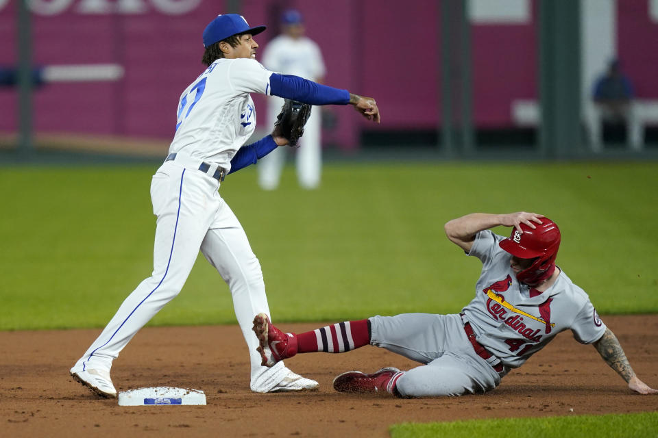 Kansas City Royals shortstop Adalberto Mondesi, left, forces out St. Louis Cardinals Tyler O'Neill (41) during the second inning of a baseball game in Kansas City, Mo., Monday, Sept. 21, 2020. (AP Photo/Orlin Wagner)