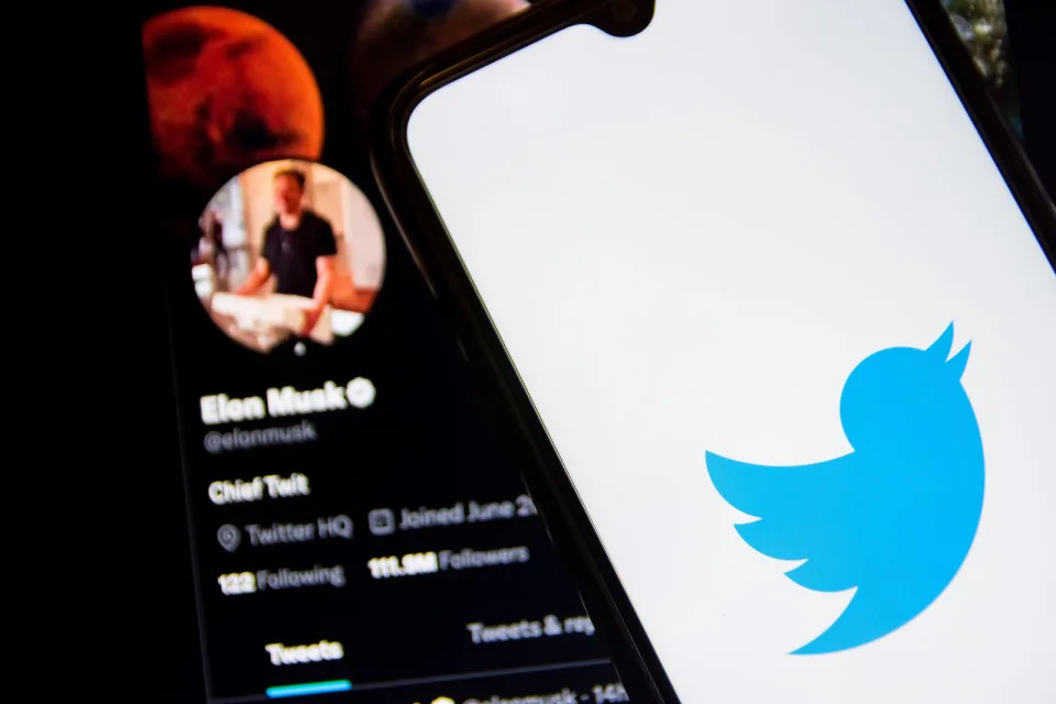 In this photo illustration a Twitter logo seen displayed on a smartphone screen with Elon Musk Twitter in the background in Athens, Greece on October 30, 2022. Elon Musk begins his Twitter ownership with firings. (Photo by Nikolas Kokovlis/NurPhoto via Getty Images)