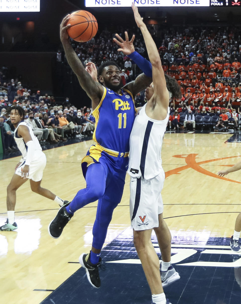 Pittsburgh guard Jamarius Burton (11) shoots next to Virginia forward Kadin Shedrick (21) during an NCAA college basketball game in Charlottesville, Va., Friday, Dec. 3, 2021. (AP Photo/Andrew Shurtleff)