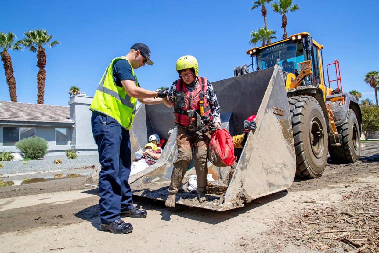 Cathedral City Fire firefighters rescue residents of an elderly care home after the home and roads were inundated with mud from Tropical Storm Hilary in Cathedral City, Calif., on Monday, August 21, 2023.