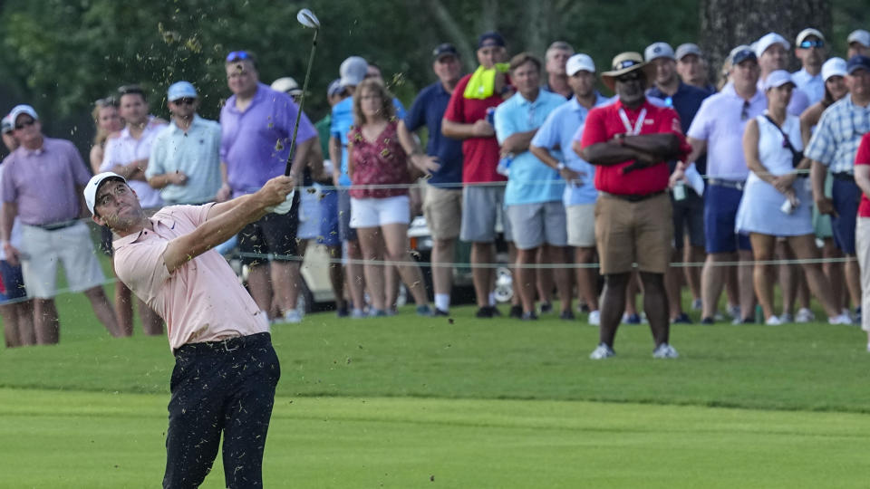 Scottie Scheffler chips the ball to the 18th green during the second round of the Tour Championship golf tournament at East Lake Golf Club, Friday, Aug. 26, 2022, in Atlanta. (AP Photo/Steve Helber)