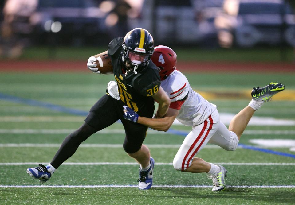 McQuaid’s Eoin Meyer is tackled by Fairport’s Nicolas Davis on this kick return.