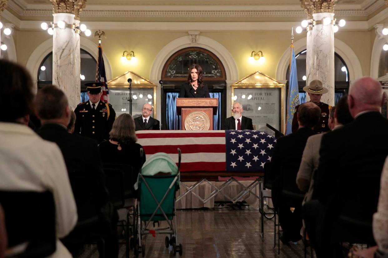 South Dakota Gov. Kristi Noem speaks during the memorial for former Gov. Frank Farrar in Pierre, S.D., on Tuesday, Nov. 9, 2021. He died last month at the age of 92 after an injury to his head. Farrar was known as the "boy wonder" of South Dakota politics after he became the youngest person ever elected state attorney general in 1962.