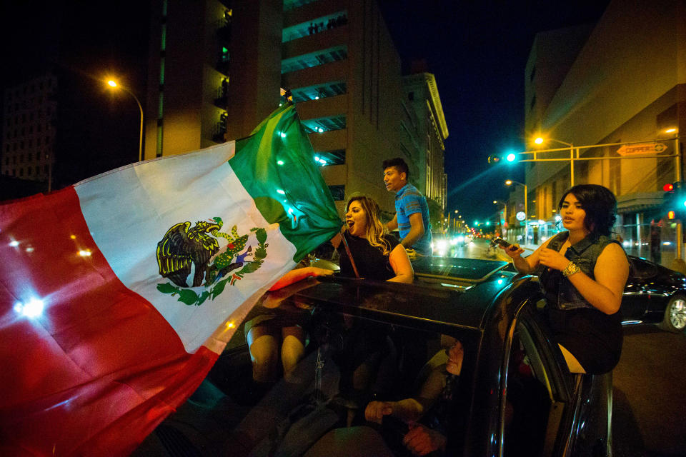 <p>A woman waves the Mexican flag while driving past the Albuquerque Convention Center after a rally by Republican presidential candidate Donald Trump, Tuesday, May 24, 2016, in Albuquerque, N.M. (Jett Loe/The Las Cruces Sun-News via AP) </p>