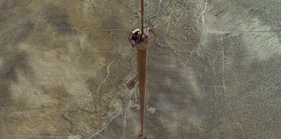 One girl holds the rope while another scales down a 2000 ft tower.