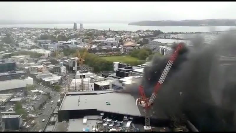 Smoke rises as a fire blazes at Sky City Convention Centre, which is under construction in Auckland