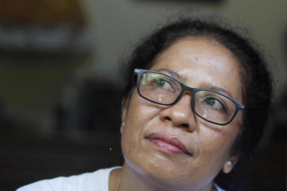 Ni Luh Erniati sits in her home in Bali, Indonesia on Friday, April 26, 2019. Erniati's husband, Gede Badrawan, was one of 202 people killed in the 2002 Bali bombings. For years after the bombings, she was consumed by rage toward the perpetrators, but has since reconciled with a former bombmaker whose brothers helped orchestrate the attack as part of a peacebuilding program bringing together ex-terrorists and victims. (AP Photo/Firdia Lisnawati)