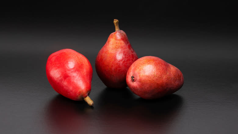 Starkrimson pears on black background