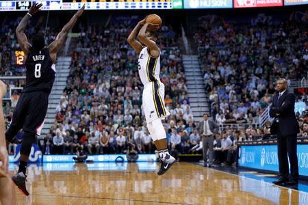 Apr 8, 2016; Salt Lake City, UT, USA; Utah Jazz guard Rodney Hood (5) shoots a three pointer against Los Angeles Clippers forward Jeff Green (8) in the fourth quarter at Vivint Smart Home Arena. The Los Angeles Clippers defeated the Utah Jazz 102-99 in overtime. Mandatory Credit: Jeff Swinger-USA TODAY Sports