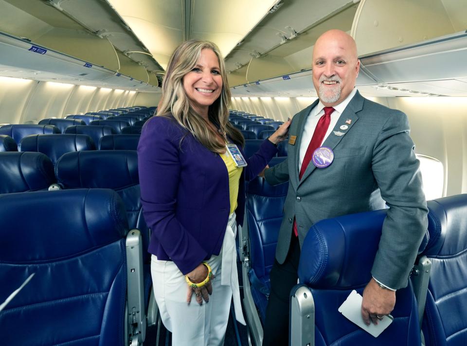 Joanne Magley, director of marketing and customer experience for Daytona Beach International Airport, stands next to Volusia County Council member Matt Reinhart the inside of an Avelo Airlines 737-700 jetliner that the ultra low-cost carrier used for its inaugural nonstop flight to Daytona Beach from New Haven, Connecticut, Thursday, June 22, 2023.