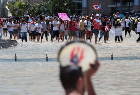 Students of the University of Puerto Rico protest as a meeting of the Financial Oversight and Management Board for Puerto Rico is taking place at the Convention Center in San Juan, Puerto Rico March 31, 2017. Picture taken March 31, 2017. REUTERS/Alvin Baez