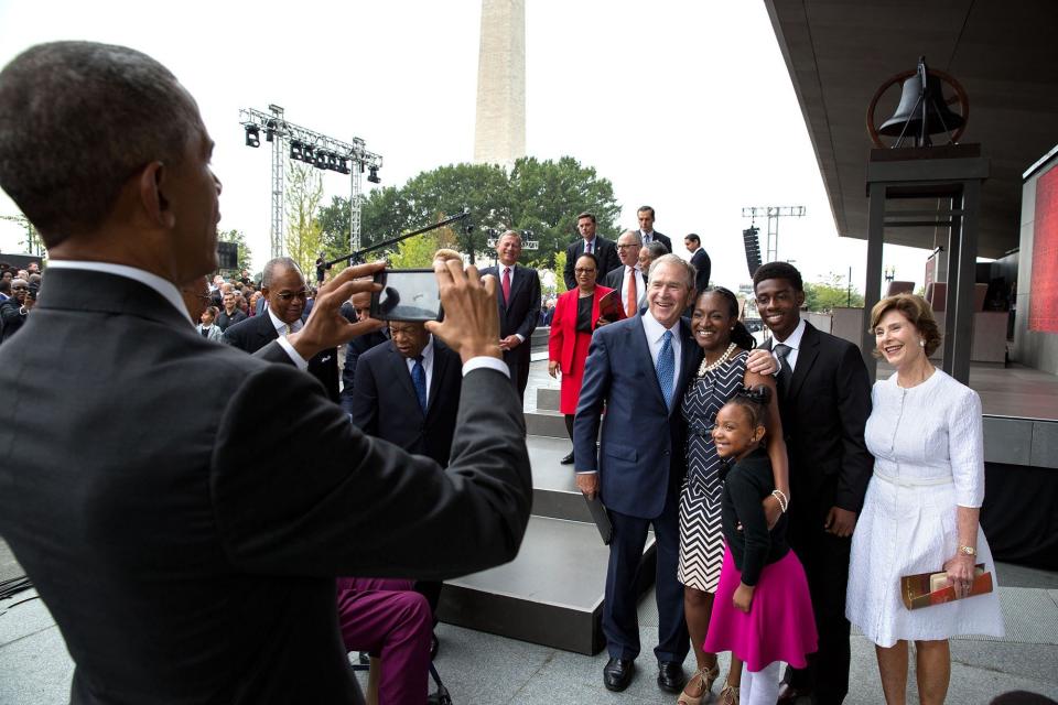 Obama snaps a photo of former President George W. Bush and former first lady Laura Bush with the Bonner family after the opening of the National Museum of African American History and Culture in Washington, D.C. on Sept. 24.