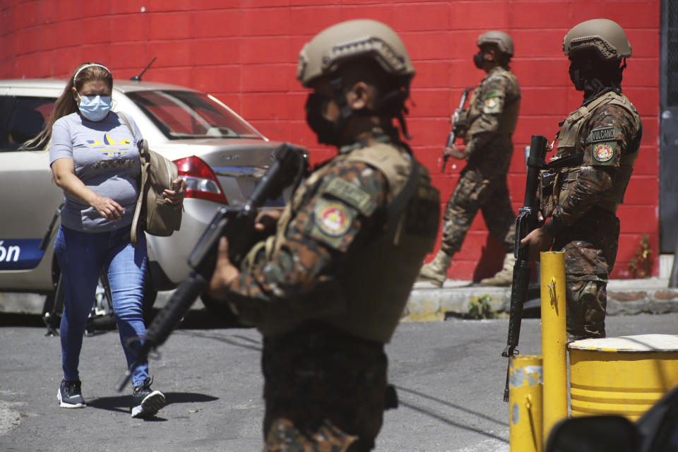 Soldiers man a checkpoint at the entrance to the Las Palmas Community, a neighborhood that is supposed to be under the control of Barrio 18 Gang in San Salvador, El Salvador, Sunday, March 27, 2022. El Salvador's congress has granted President Nayib Bukele request to declare a state of emergency, amid a wave of gang-related killings over the weekend. (AP Photo/Salvador Melendez)