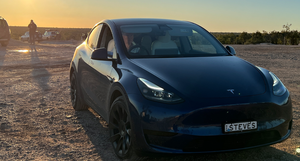 The Tesla Model Y of Steve Brine and Tracey McClintock on a dirt road in the Australian outback. 