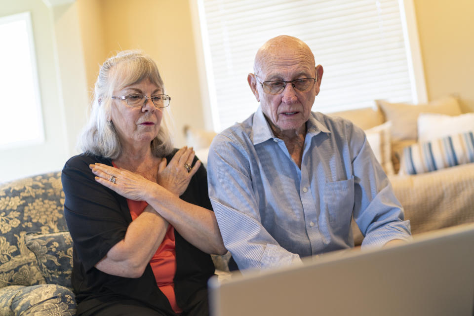 Sandy Phillips, left, practices mindfulness techniques while running through a presentation with her husband, Lonnie, at a friend’s home in Lone Tree, Colo., Tuesday, Sept. 5, 2023. The couple is preparing to teach a seminar to help shooting victims and gun control advocates deal with trauma. Suffering through their own personal loss after a mass shooting in Colorado claimed Sandy’s daughter, Jessica Ghawi, in 2012, the couple set out to help other parents like them, traveling to shooting sites around the country. The trip continued for a decade. (AP Photo/David Goldman)