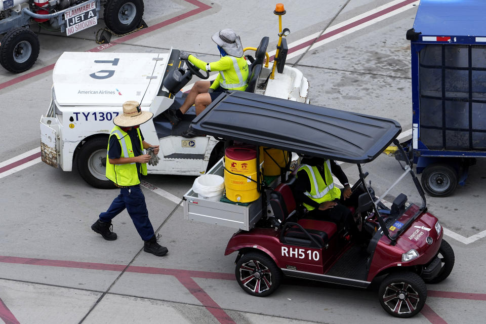 Water is delivered to grounds crew working on the tarmac at Sky Harbor International Airport, Monday, July 10, 2023 in Phoenix. Phoenix is the epicenter of what may turn out to be an unprecedented extreme heat wave around the Southwest. (AP Photo/Matt York)
