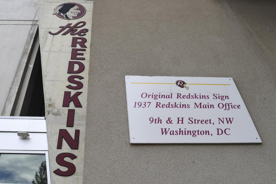 Signs for the Washington Redskins are displayed outside FedEx Field in Landover, Md., Monday, July 13, 2020. The Washington NFL franchise announced Monday that it will drop the "Redskins" name and Indian head logo immediately, bowing to decades of criticism that they are offensive to Native Americans. (AP Photo/Susan Walsh)