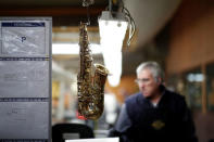 A part of a saxophone hangs at the Henri Selmer wind instruments factory in Mantes-la-Ville near Paris, France, January 17, 2018. REUTERS/Benoit Tessier