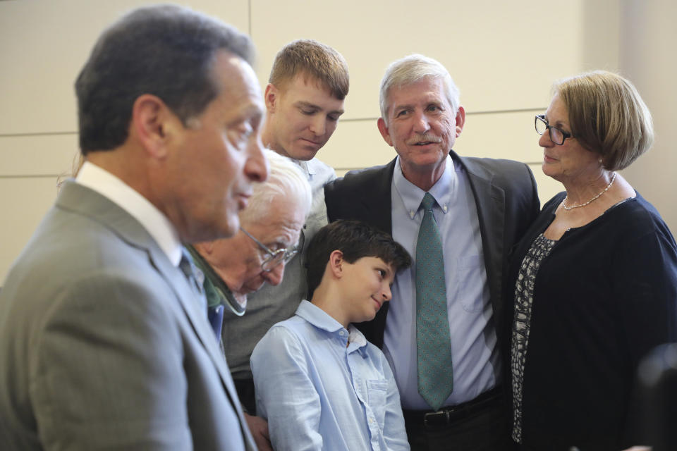 Attorney Lee Plakas talks Thursday, June 13, 2019, in Elyria, Ohio, about the decision in his clients' lawsuit claiming Oberlin College hurt their business and libeled them. In the background are Allyn W. Gibson, Allyn D. Gibson, Cashlyn Gibson, 11, David Gibson, and Lorna Gibson. A jury in Lorain County awarded David Gibson, son Allyn Gibson and Gibson's Bakery, of Oberlin, $33 million in punitive damages Thursday. That comes on top of an award a day earlier of $11 million in compensatory damages. (Bruce Bishop/Chronicle-Telegram via AP)