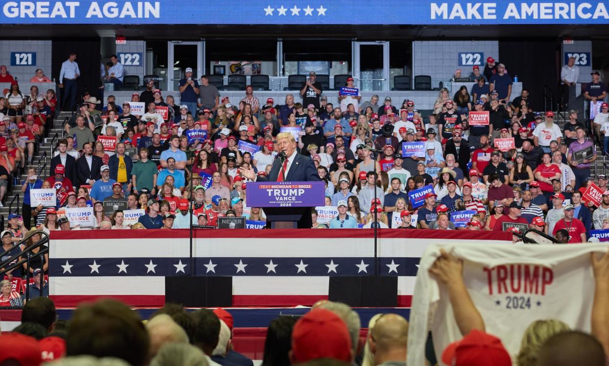 <span>Trump speaks at the Van Andel Arena in Grand Rapids, Michigan, on 20 July 2024.</span><span>Photograph: Allison Dinner/EPA</span>