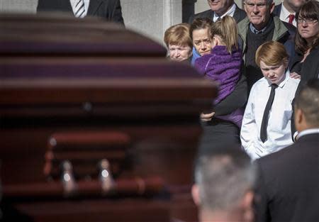 Mimi O'Donell (C), former partner of actor Phillip Seymour Hoffman, holds her daughter Willa as the casket arrives for the funeral of actor Phillip Seymour Hoffman in the Manhattan borough of New York, February 7, 2014. REUTERS/Brendan McDermid