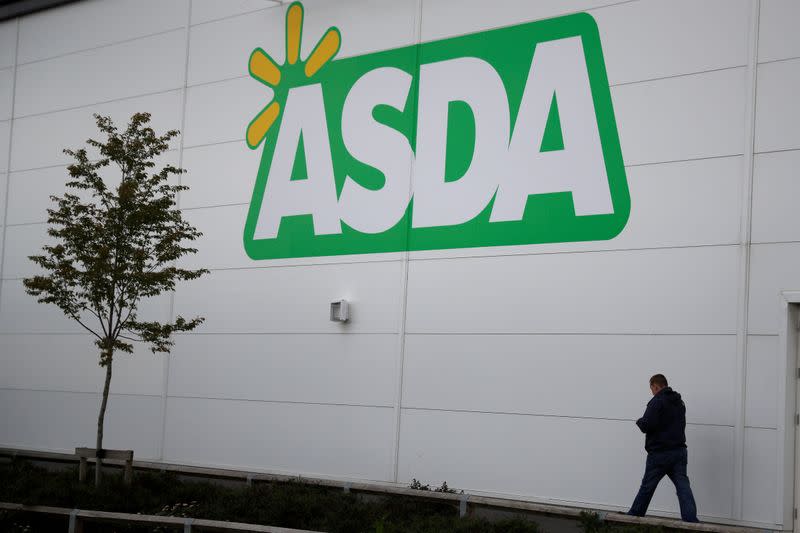 FILE PHOTO: A man walks past a branch of ASDA in Altrincham.