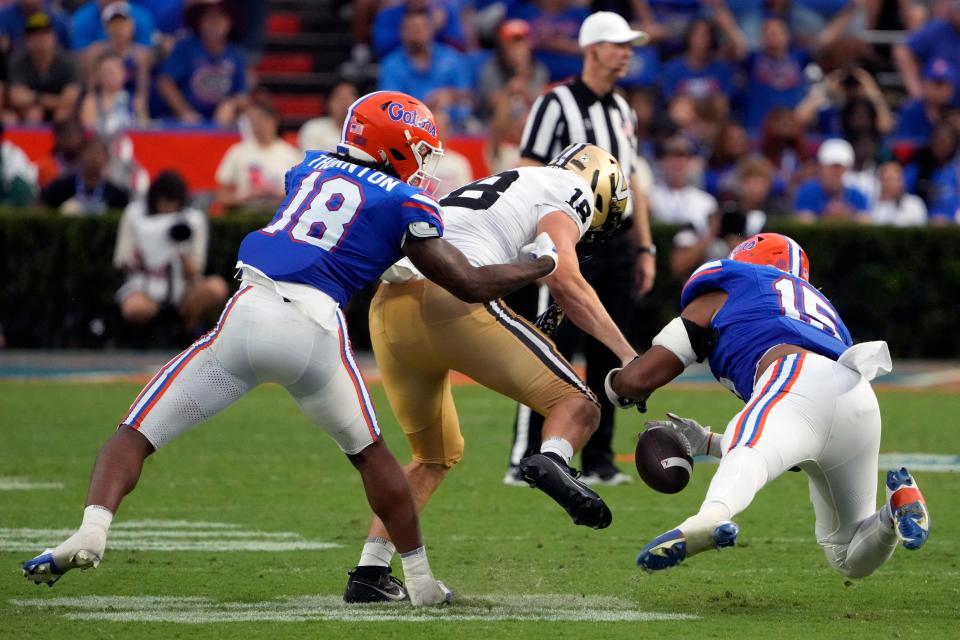 Florida safety Bryce Thornton, left, and linebacker Derek Wingo, right, break up a pass intended for Vanderbilt tight end Logan Kyle, center, during the second half of an NCAA college football game, Saturday, Oct. 7, 2023, in Gainesville, Fla. (AP Photo/John Raoux)