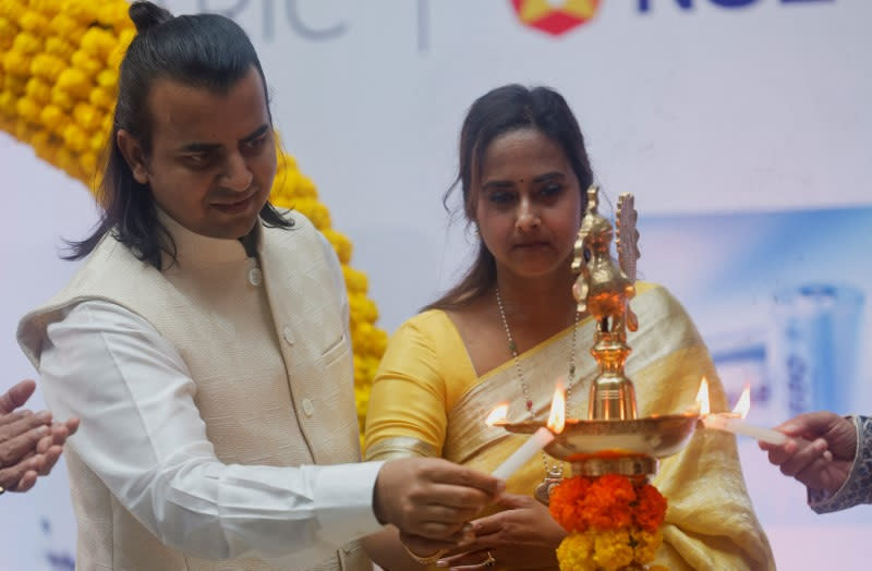 Bhavish Aggarwal, CEO of Ola Cabs and founder of Ola Electric and his wife, Rajalakshmi Aggarwal light the ceremonial lamp ahead of Ola Electric's listing ceremony at the National Stock Exchange (NSE) in Mumbai