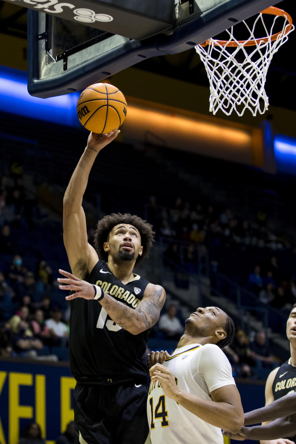 Colorado guard J'Vonne Hadley, left, shoots in front of California forward Grant Newell (14) during the first half of an NCAA college basketball game in Berkeley, Calif., Saturday, Dec. 31, 2022. (AP Photo/John Hefti)