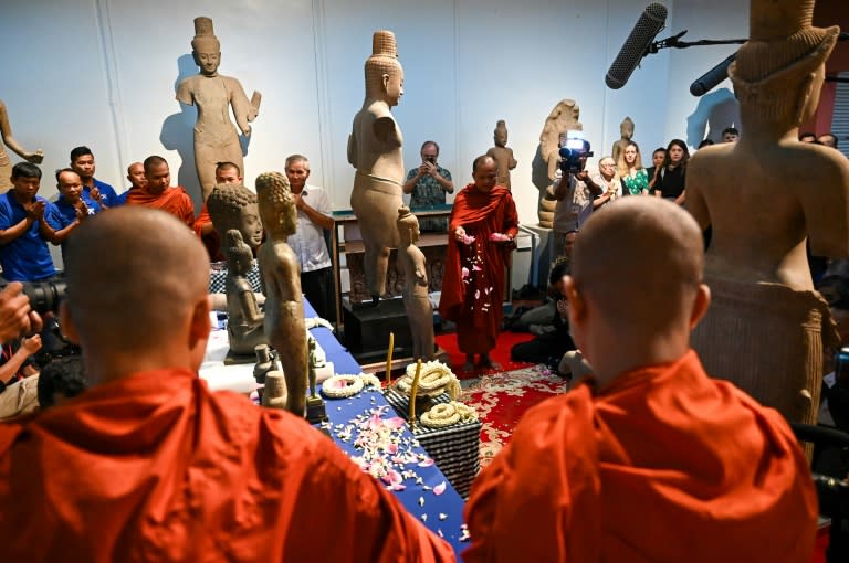 Buddhist monks chanted blessings and threw flowers to welcome the artefacts back to Cambodia (TANG CHHIN SOTHY)