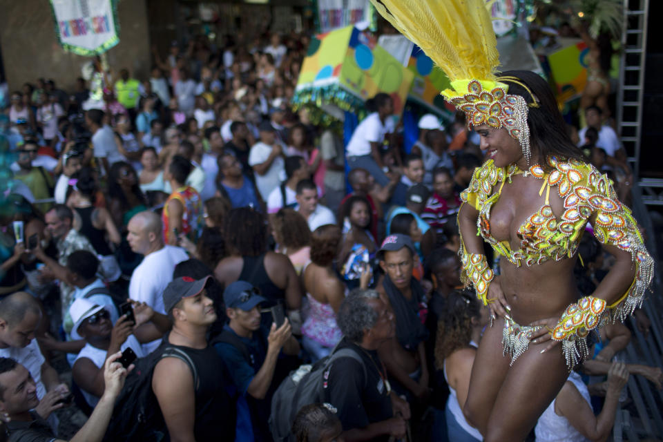 In this photo taken Saturday, Feb. 2, 2013, samba dancer Diana Prado performs during a carnival parade at central station in Rio de Janeiro, Brazil. Prado spends her daylight hours working as a supervisor at a call center. At night, she is a samba dancer, or "passista," as they're known in Portuguese. Prado made her Carnival debut at age 19, after auditioning for a spot with the Sao Clemente, one of 13 top-tier schools that will compete for the annual titles at the Sambadrome this weekend. (AP Photo/Felipe Dana)