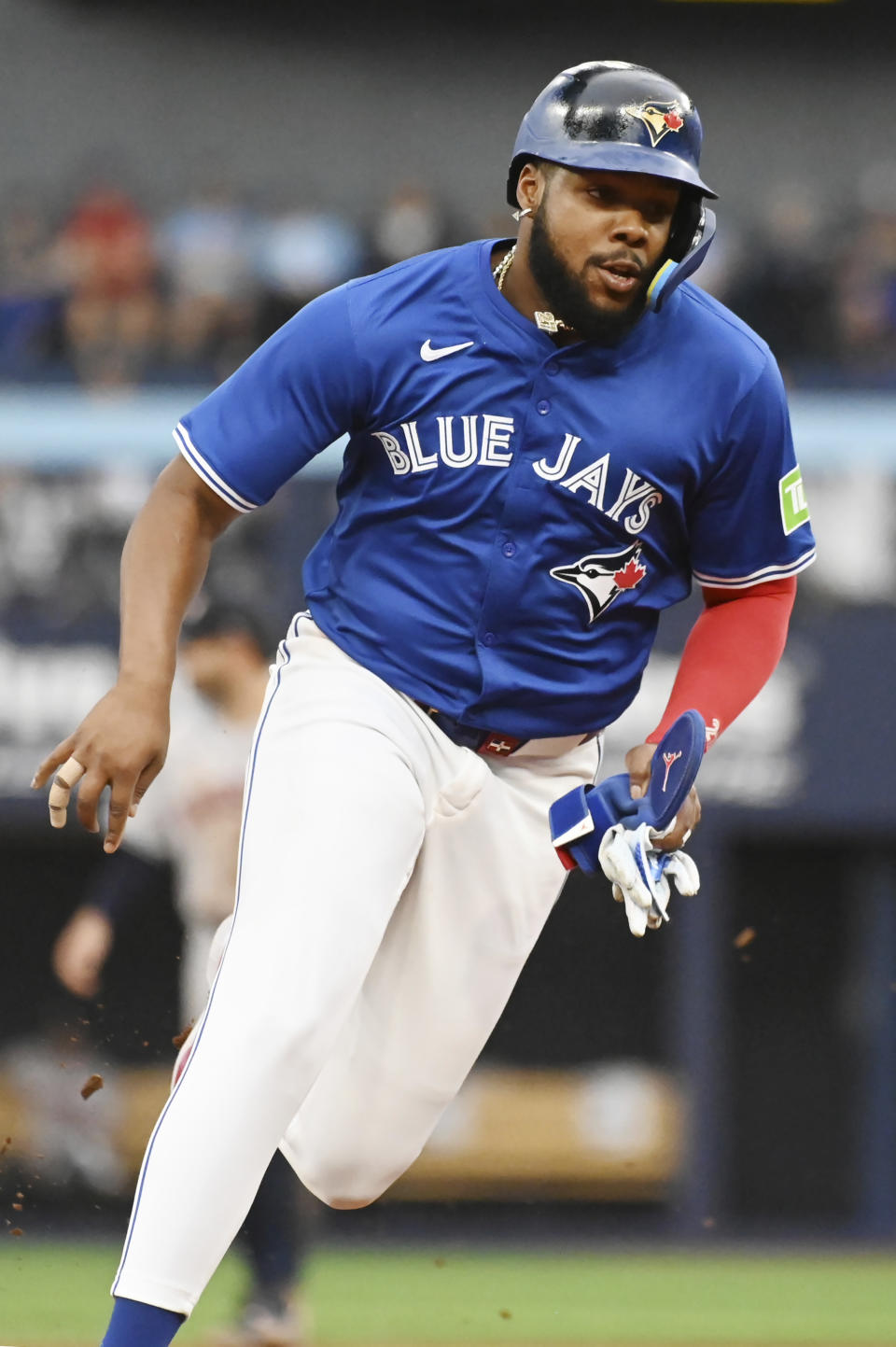 Toronto Blue Jays' Vladimir Guerrero Jr. (27) rounds third base to score on an RBI single by teammate Justin Turner (not shown) against the Houston Astros during the first inning of a baseball game, Tuesday, July 2, 2024, in Toronto. (Jon Blacker/The Canadian Press via AP)