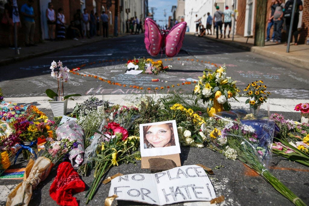 Flowers and notes are left in memory of Heather Heyer, who died after she was struck when a car plowed into a crowd protesting the 'Unite the Right' rally on Aug. 12, 2017, in Charlottesville, Va.