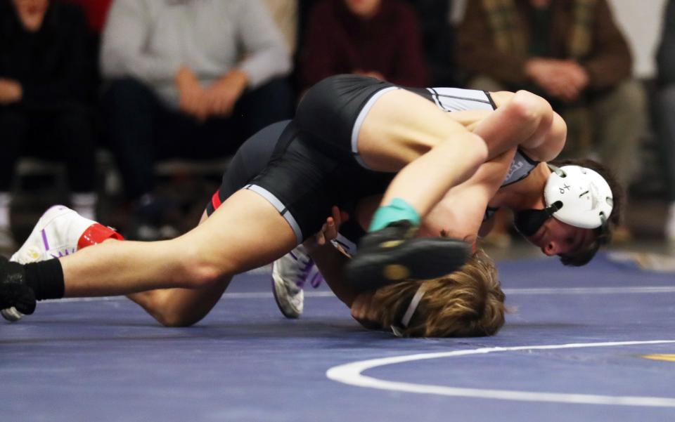 Byram Hills/Briarcliff/Valhalla/WestlakeÕs Vincenzo Mannello and RyeÕs Ari Bisongi wrestle in the 101-pound weight class during the dual meet quarterfinals at Byram Hills High School Dec. 19, 2023. Mannello won the match.