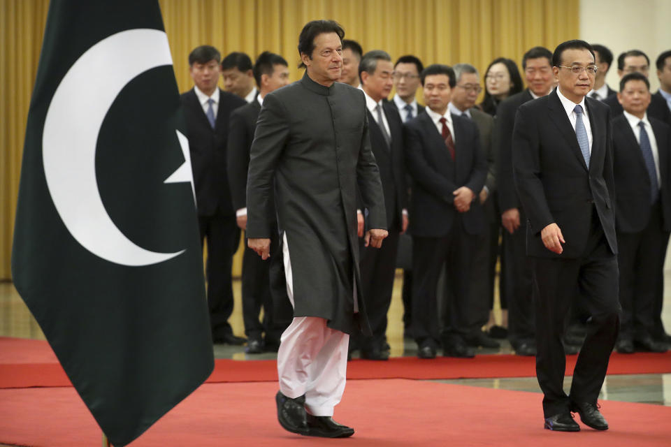 Pakistan's Prime Minister Imran Khan, left, and Chinese Premier Li Keqiang walk together during a welcome ceremony at the Great Hall of the People in Beijing, Saturday, Nov. 3, 2018. (AP Photo/Mark Schiefelbein)