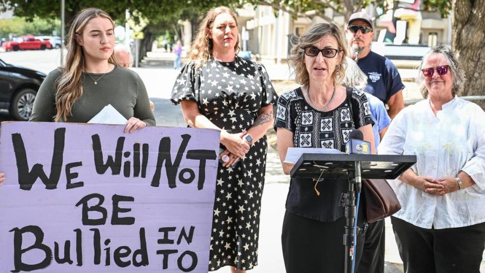 Kriszti Mendoca, an Oakhurst small business owner, reads a statement about her name being printed on a political flyer from Madera County supervisor candidate Mark Reed as connected to the “Witches and Warlocks” and supporting his “opponent” in the June 7 election, during a press conference in Fresno on Thursday, June 2, 0222.