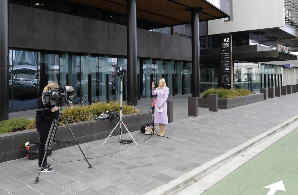 Media film outside the Christchurch High Court in Christchurch, New Zealand, Thursday, March 26, 2020. One year after killing 51 worshipers at two Christchurch mosques, an Australian white supremacist accused of the slaughter on Thursday changed his plea to guilty. Twenty-nine-year-old Brenton Harrison Tarrant pleaded guilty to 51 counts of murder, 40 counts of attempted murder and one count of terrorism. (AP Photo/Mark Baker)