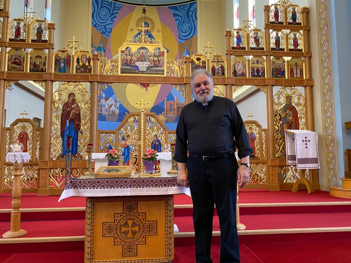 Father Michael Kwiatkowski represents an established Ukrainian community in Winnipeg’s north-end. They're preoccupied with the war in Ukraine but he says they still want to be a part of this journey to reconciliation.  (Karen Pauls/CBC  - image credit)