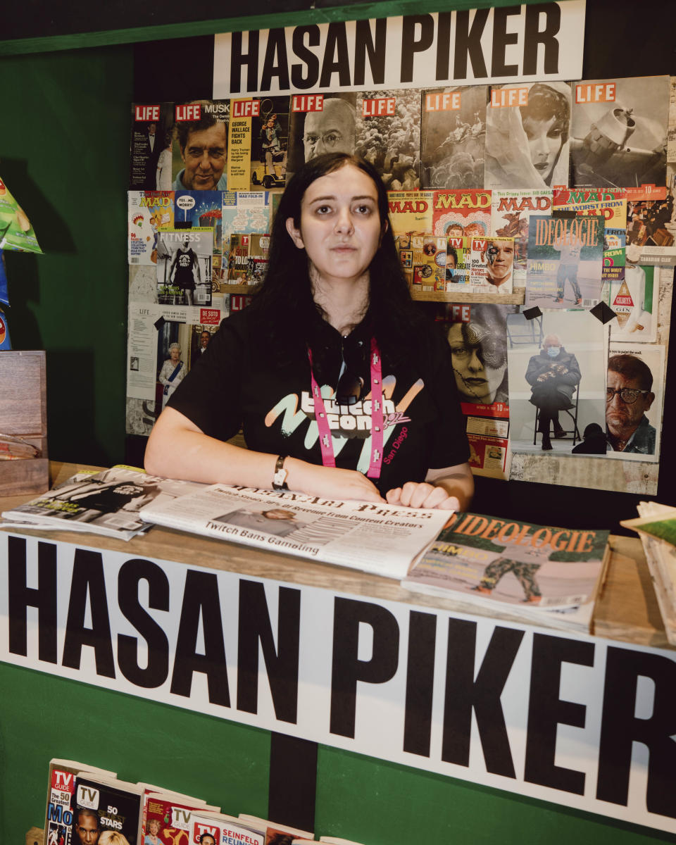 Sorrenti poses at Hasan Piker's TwitchCon newsstand themed booth. (NBC News)