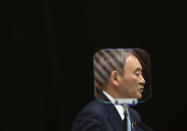 Japanese Prime Minister Yoshihide Suga is seen through a teleprompter as he speaks during his news conference at his office in Tokyo, Thursday, Sept. 9, 2021. Japan announced Thursday it is extending a coronavirus state of emergency in Tokyo and 18 other areas until the end of September as health care systems remain under severe strain, although new infections have slowed slightly. (Kim Kyung-Hoon/Pool Photo via AP)