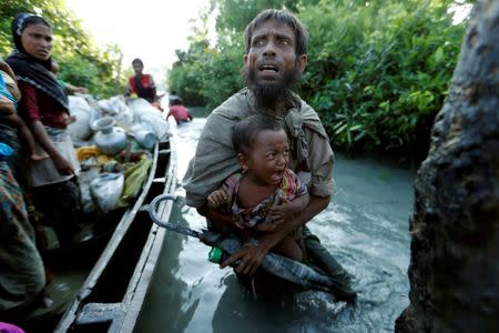 Rohingya refugees arrive at the Bangladeshi side of the Naf River after crossing the border from Myanmar, in Palang Khali, Bangladesh, October 16, 2017. REUTERS/Jorge Silva/Files