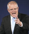 Australian Prime Minister Scott Morrison gestures as he speaks to party supporters after his opponent concedes defeat in the federal election in Sydney, Australia, Sunday, May 19, 2019. Australia's ruling conservative coalition, lead by Morrison, won a surprise victory in the country's general election, defying opinion polls that had tipped the center-left opposition party to oust it from power and promising an end to the revolving door of national leaders. (AP Photo/Rick Rycroft)