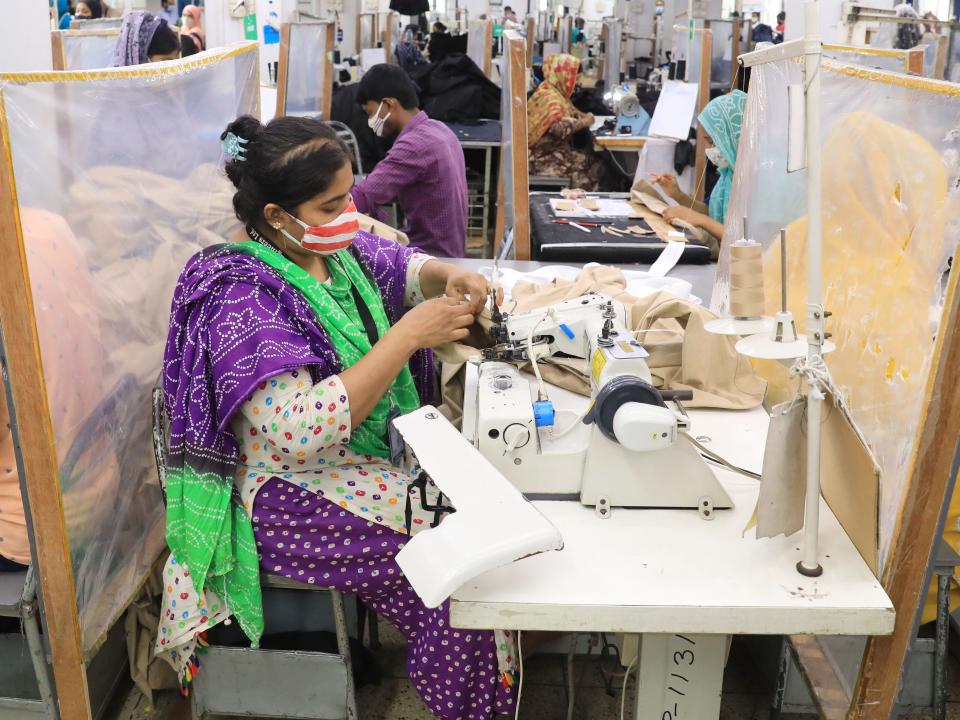People in a textile factory in Bangladesh work on making clothing