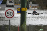 A man paddles his kayak through a flooded street at Windsor on the outskirts of Sydney, Australia, Tuesday, July 5, 2022. Hundreds of homes have been inundated in and around Australia's largest city in a flood emergency that was impacting 50,000 people, officials said Tuesday. (AP Photo/Mark Baker)