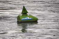 A river buoy on the Danube river has the sunken tourist boar painted on it during a memorial ceremony for the victims, one year after the Mermaid boat accident, in Budapest, Hungary, Friday, May 29, 2020. Commemorations are taking place on the one year anniversary of the Danube River tragedy in which a sightseeing boat carrying mostly tourists from South Korea sank after a collision with a river cruise ship that killed at least 27 people. (AP Photo/Laszlo Balogh)