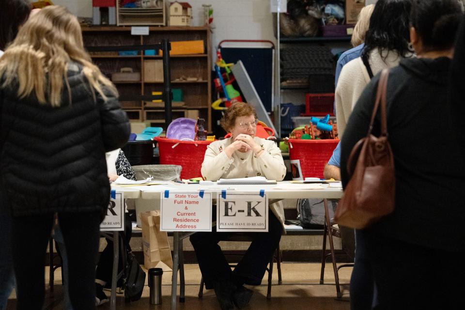 Nov 7, 2023; Columbus, OH, USA;
Flossie Callderone waits for residents with last names with E-K to check in to vote at Burbank Early Childhood School on Tuesday, Nov. 7, 2023.
